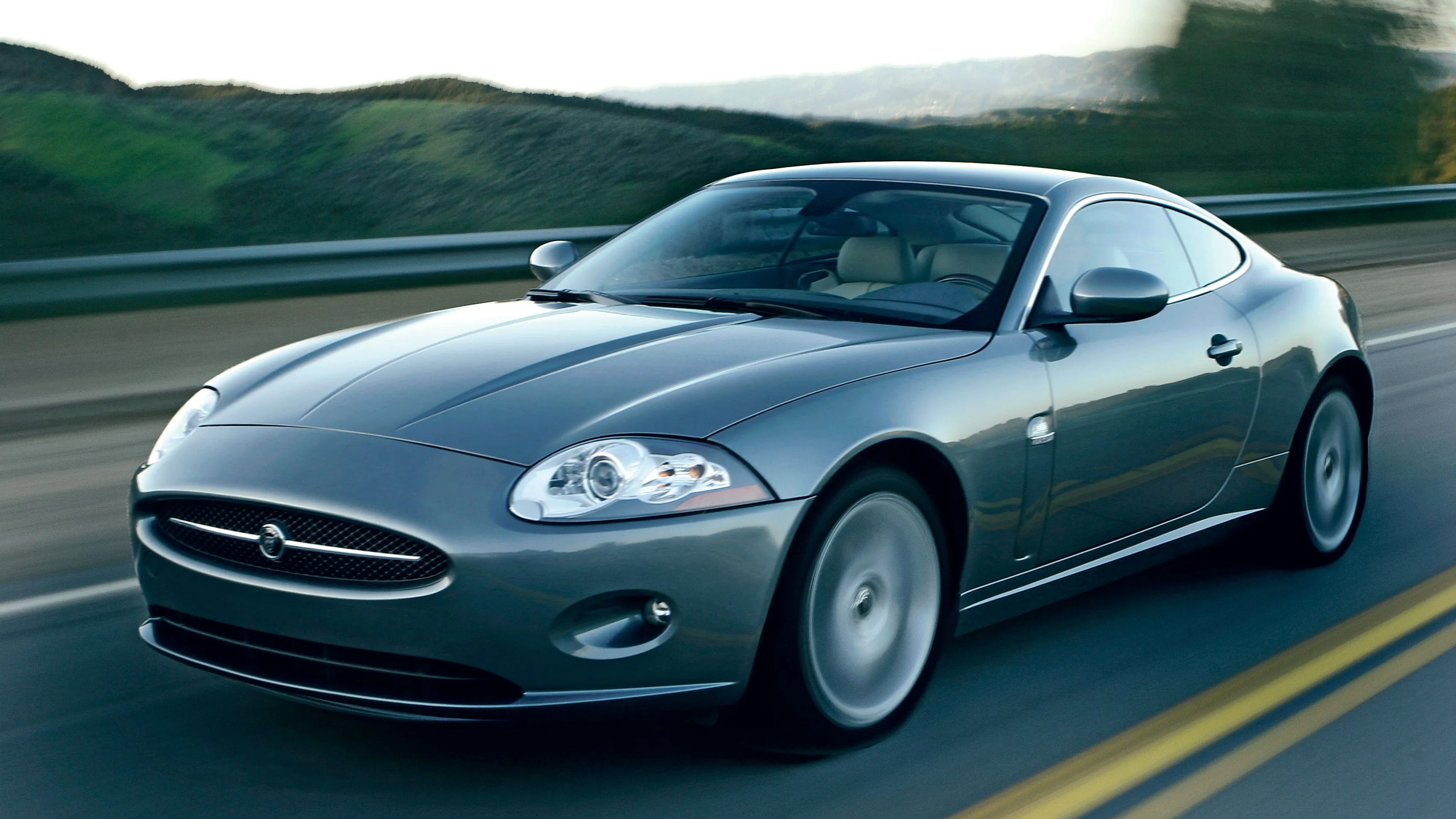 2007 Jaguar XK coupe showcasing Aston Martin inspired styling and grand touring performance