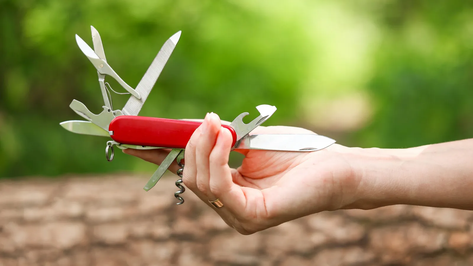 Backpacker reviewing top multitool options for outdoor survival and trail maintenance