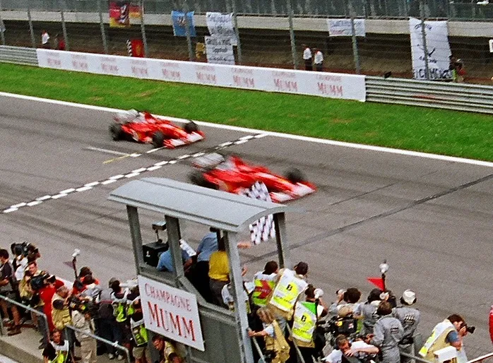 Formula One racing cars navigating a high speed circuit turn during a grand prix event