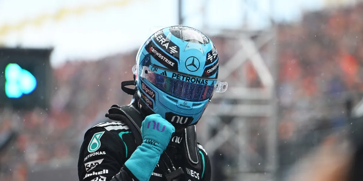 George Russell celebrates winning the Dutch Grand Prix sprint race at Zandvoort ahead of Charles Leclerc