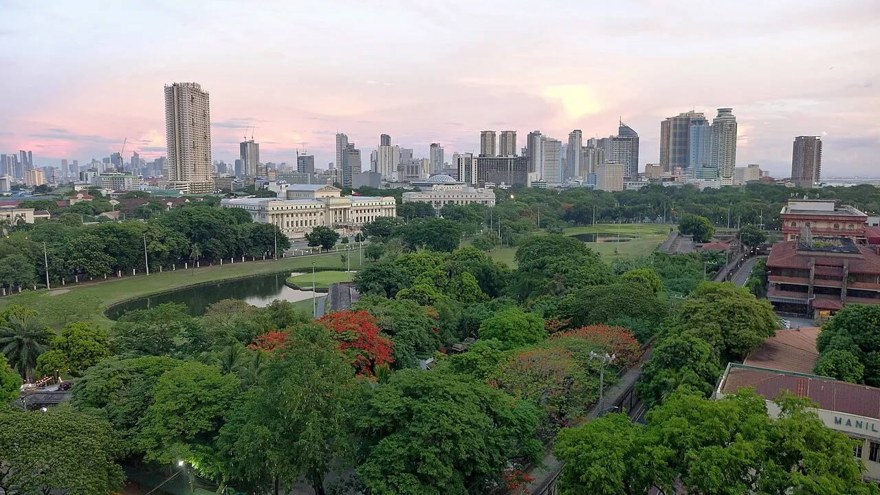 Manila skyline showcasing urban density and historical landmarks along the bay
