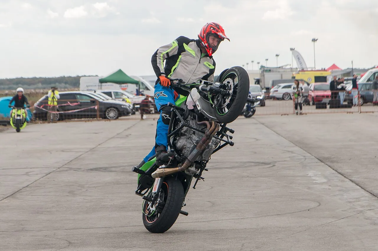 Motorcycle stunt riders perform high-speed wheelies on public highways amid increasing police crackdowns