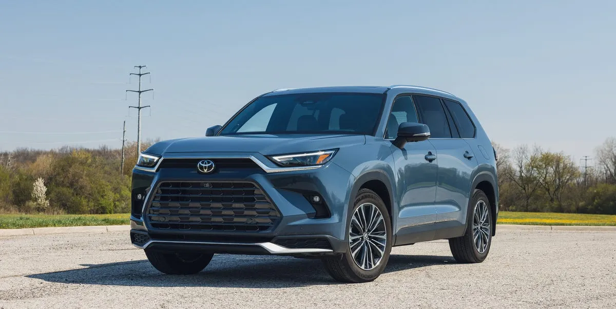 2026 Toyota Grand Highlander Hybrid parked on a scenic road offering family comfort
